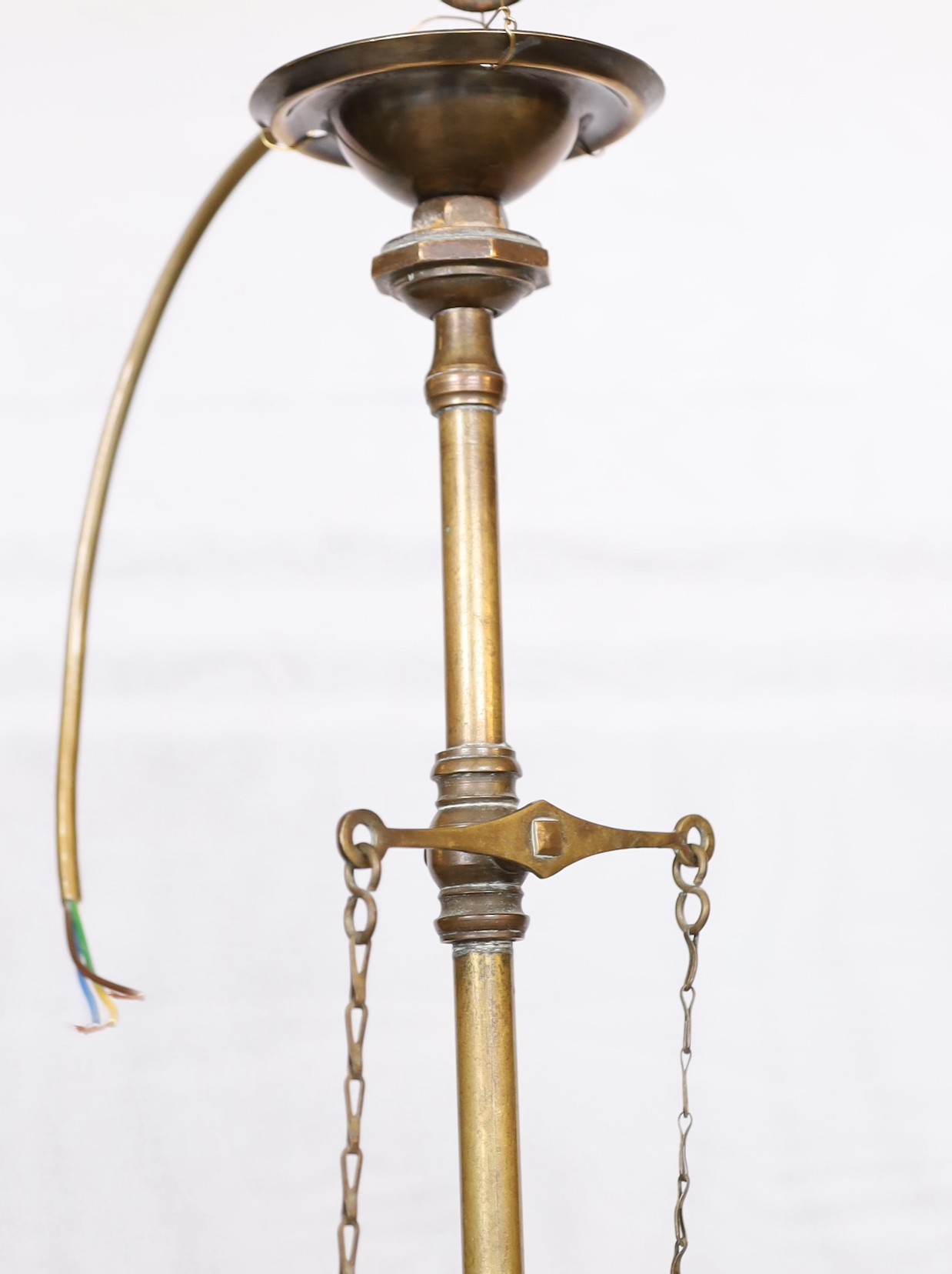 An early 20th century English brass gasolier light fitting, converted to electricity, with pink tinted etched glass shade, height 50cm